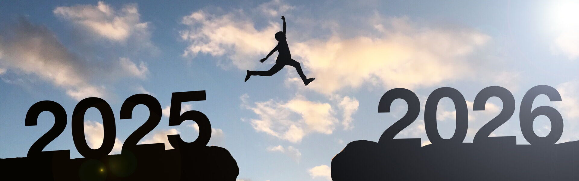 Eine Person springt von Klippe zu Klippe, die "2025" und "2026" zeigen. Ein Sinnbild für ein Kick Off Event mit bo events.